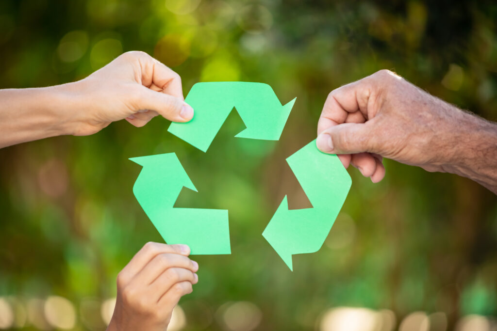 people holding recycle symbol against green spring 2023 11 27 05 18 18 utc